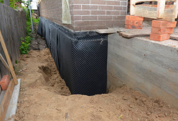 SJ Waterproofing Pros technician performing targeted Interior Drainage System assessment in Summerdale, AL